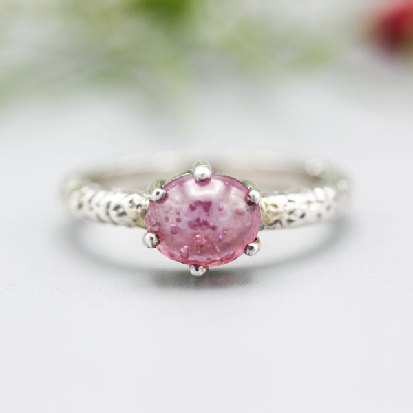 Oval cabochon pink sapphire ring with sterling silver texture band