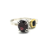 Oval faceted garnet ring in silver bezel and double prongs setting with green tourmaline on the side on sterling silver hammer texture band
