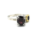 Oval faceted garnet ring in silver bezel and double prongs setting with green tourmaline on the side on sterling silver hammer texture band
