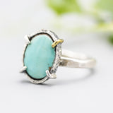 Oval turquoise ring in silver bezel and prongs setting with sterling silver oxidized hammer texture band