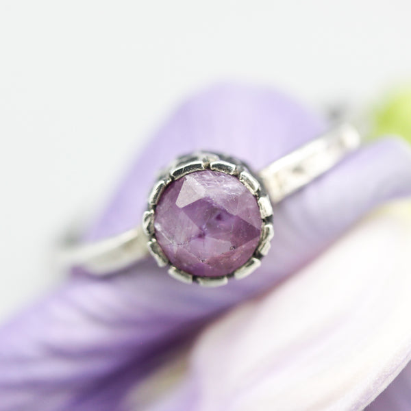 Round faceted pink sapphire ring in bezel setting with sterling silver hammer texture band