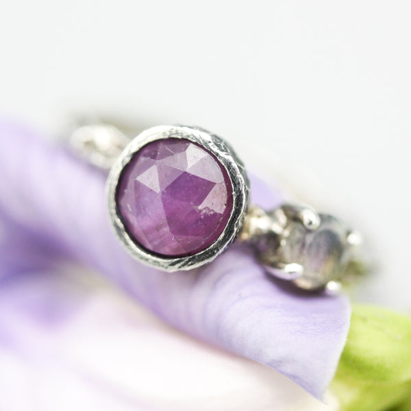 Round faceted pink sapphire ring with round labradorite on the side and sterling silver hard texture band