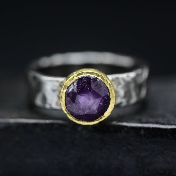 Round faceted pink sapphire ring in brass bezel setting with sterling silver hammer texture band