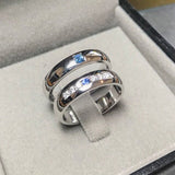 Wedding band set his and hers with blue sapphire and diamonds on white gold in high polished band