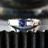 Wedding band ring with blue sapphire on white gold in high polished band