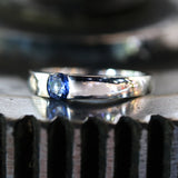 Wedding band ring with blue sapphire on white gold in high polished band