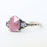 Ruby ring with moonstone side set gems in prongs setting with sterling silver oxidized texture band