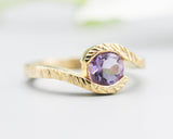 Bypass style ring 14k gold line texture design with round faceted Amethyst at the center