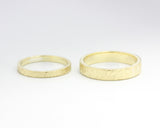 Set of his and her wedding bands ring in 18k gold in hammered texture