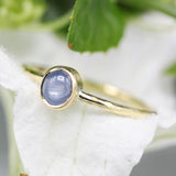 Oval Blue star sapphire in bezel settings with 18k gold texture band