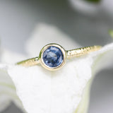 Round cut Blue sapphire ring in bezel settings with 18k gold texture band