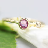 Oval ruby ring in bezel setting and tiny diamond with 18k gold texture band