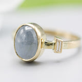 Oval blue star sapphire ring and diamond secondary with 18k gold texture band