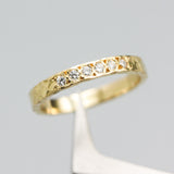 Tiny diamond eternity ring with 18k yellow gold band