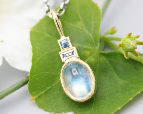 Oval Moonstone, square blue sapphire and Princess cut Diamond in 18k gold bezel settings with oxidized sterling silver chain