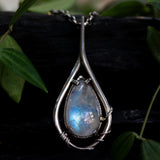 Moonstone teardrop cabochon pendant necklace in silver bezel and prongs setting with silver vine design and pink sapphire gemstone secondary