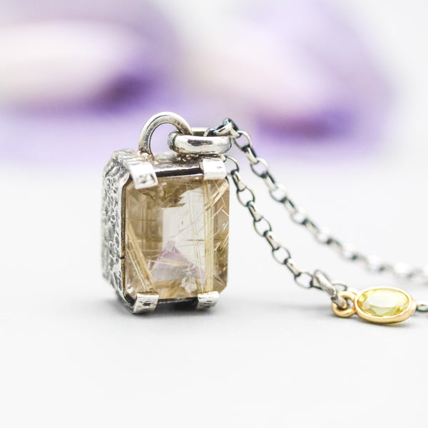 Rutilated quartz necklace in silver bezel and prongs setting with multi sapphire secondary on sterling silver oxidized chain