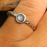 Sterling silver oxidized texture ring with round blue star sapphire in bezel setting at the center - Metal Studio Jewelry