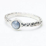 Sterling silver oxidized texture ring with round blue star sapphire in bezel setting at the center - Metal Studio Jewelry