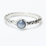 Sterling silver oxidized texture ring with round blue star sapphire in bezel setting at the center - Metal Studio Jewelry