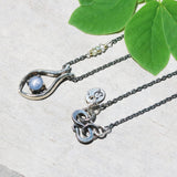 Silver fish shape necklace and cabochon star blue sapphire at the center with aquamarine beads secondary on oxidized sterling silver chain - Metal Studio Jewelry