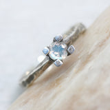 Tiny round faceted moonstone ring in silver prongs setting with sterling silver hard texture oxidized band - Metal Studio Jewelry