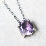 Oval Amethyst pendant necklace in silver bezel and prongs setting with amethyst beads secondary on oxidized sterling silver chain - Metal Studio Jewelry