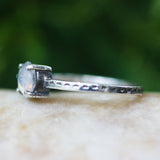 Faceted moonstone ring in silver bezel setting and blue topaz on the side with sterling silver band - Metal Studio Jewelry