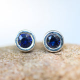 Sterling silver stud earrings with faceted blue sapphire in bezel setting with sterling silver post and backing - Metal Studio Jewelry