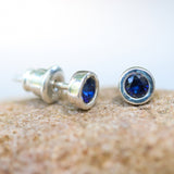 Sterling silver stud earrings with faceted blue sapphire in bezel setting with sterling silver post and backing - Metal Studio Jewelry