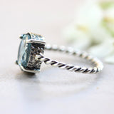 Oval faceted Swiss blue topaz ring in silver bezel and prongs setting on sterling silver oxidized twist design band - Metal Studio Jewelry
