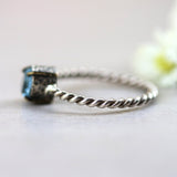 Round faceted blue topaz ring in silver bezel and brass prongs setting with sterling silver twist design band - Metal Studio Jewelry