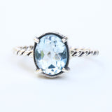 Oval faceted Swiss blue topaz ring in silver bezel and prongs setting on sterling silver oxidized twist design band - Metal Studio Jewelry