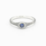 Sterling silver brush texture oxidized ring with tiny round faceted blue sapphire in silver bazel setting - Metal Studio Jewelry