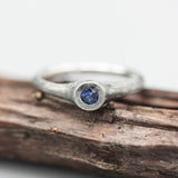 Sterling silver brush texture oxidized ring with tiny round faceted blue sapphire in silver bazel setting - Metal Studio Jewelry