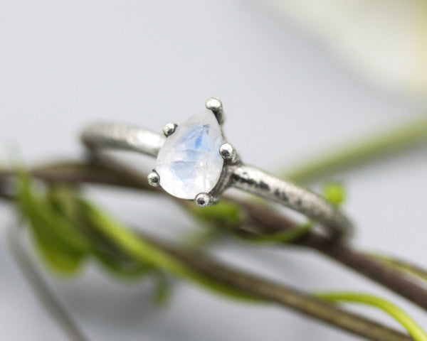 Teardrop faceted Moonstone ring in prongs setting with sterling silver oxidized texture band