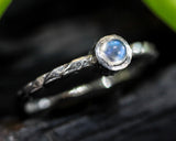 Round cabochon moonstone ring in bezel setting with sterling silver band