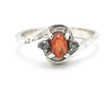 Oval sunstone ring with tiny labradorite side set gems in prongs setting with sterling silver texture band