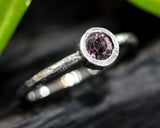 Round cut pink spinel ring in bezel setting with sterling silver texture band
