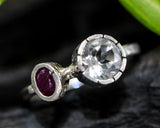 Round faceted white topaz ring in silver bezel setting and tiny ruby on sterling silver hammer texture band