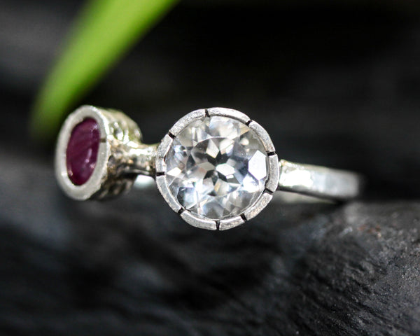 Round faceted white topaz ring in silver bezel setting and tiny ruby on sterling silver hammer texture band