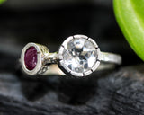 Round faceted white topaz ring in silver bezel setting and tiny ruby on sterling silver hammer texture band