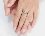 Oval cabochon moonstone ring with pink sapphire side set gems in prongs setting with sterling silver oxidized texture band