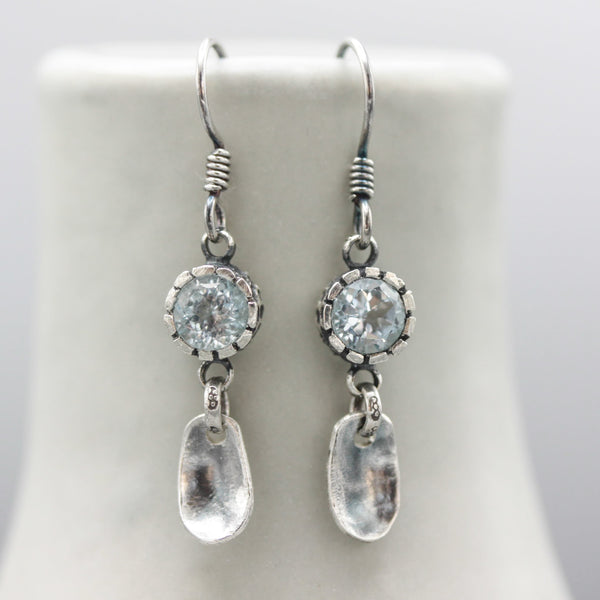 Round blue topaz earrings in silver bezel setting with silver leaf on sterling silver hooks style
