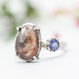 Teardrop faceted Moss agate ring with blue sapphire on the side on sterling silver hammer texture band