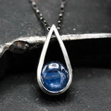 Silver teardrop pendant necklace with round cabochon blue kyanite gemstone on oxidized sterling silver chain
