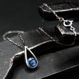 Silver teardrop pendant necklace with round cabochon blue kyanite gemstone on oxidized sterling silver chain