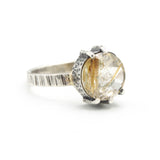 Round faceted golden rutilated quartz ring in silver bezel and prongs setting in sterling silver texture oxidized band