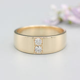 Men's ring in 18k gold featuring a high-polished band with 2 round faceted diamonds.