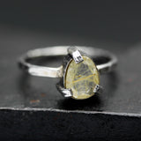 Teardrop faceted golden rutilated quartz ring in silver bezel and prongs setting in sterling silver hammer texture oxidized band